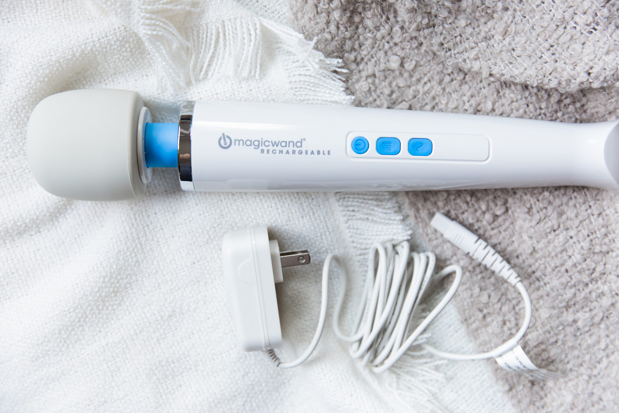 The Magic Wand Rechargeable looks just like its iconic sister, the Original, with its long, white body, rounded head, and blue accents.