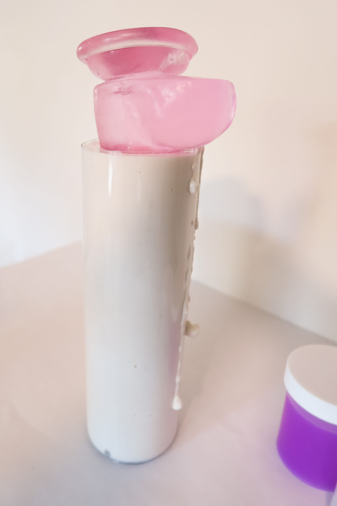 A pink dildo inside the Clone-A-Willy mold, creating the shape.