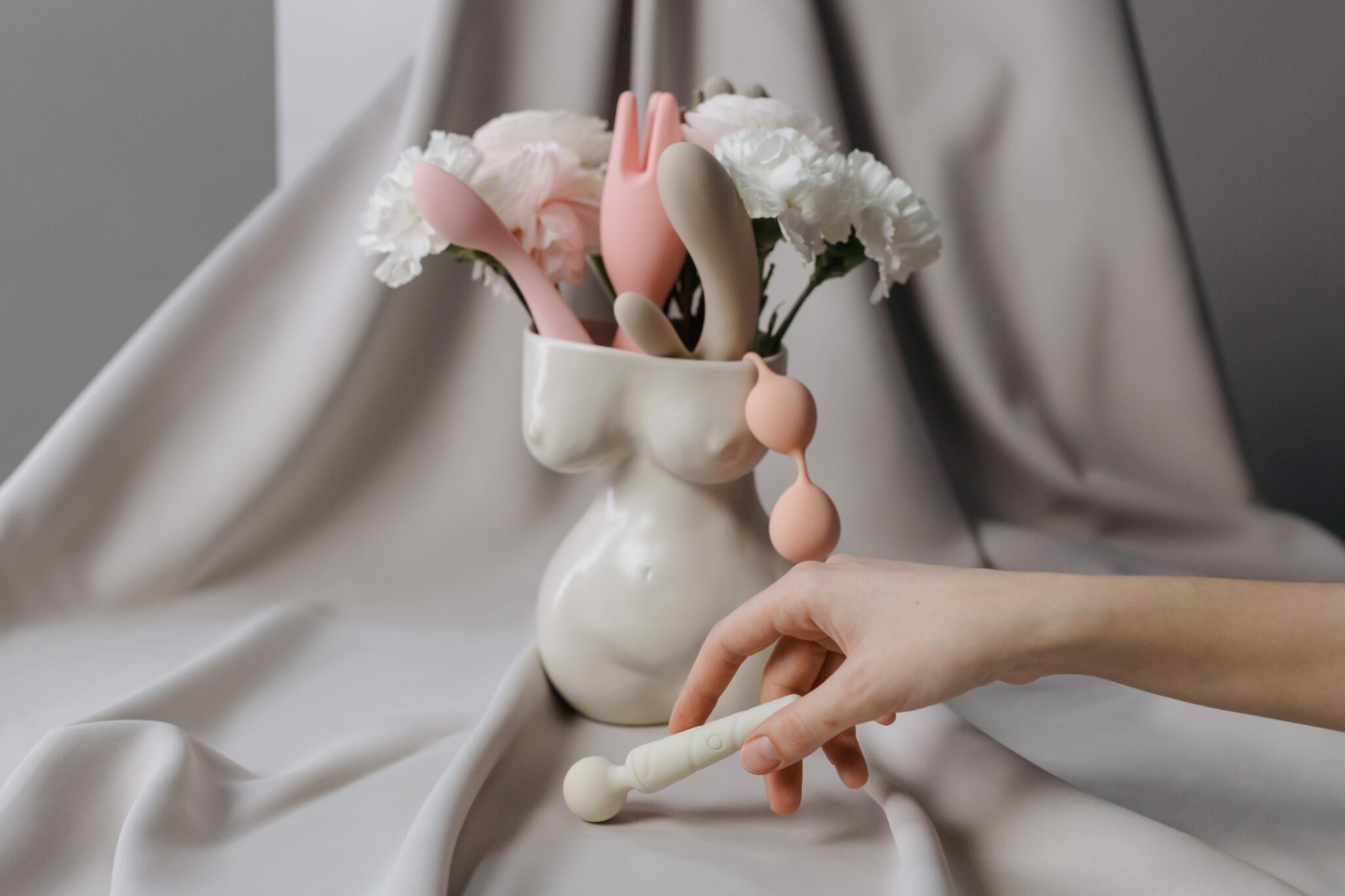 Valentine's day gift ideas, pastel sex toys in a flower vase shaped like a woman's body.