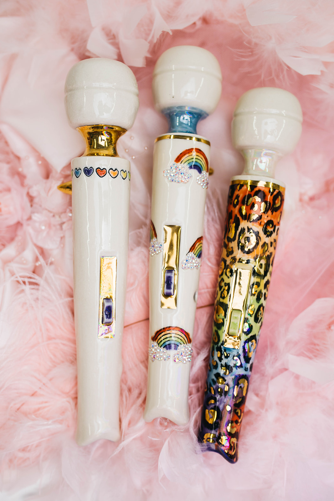 Three of the stunning Magic Wand inhaler pipes bedazzled with rainbows, leopard prints, and hearts.