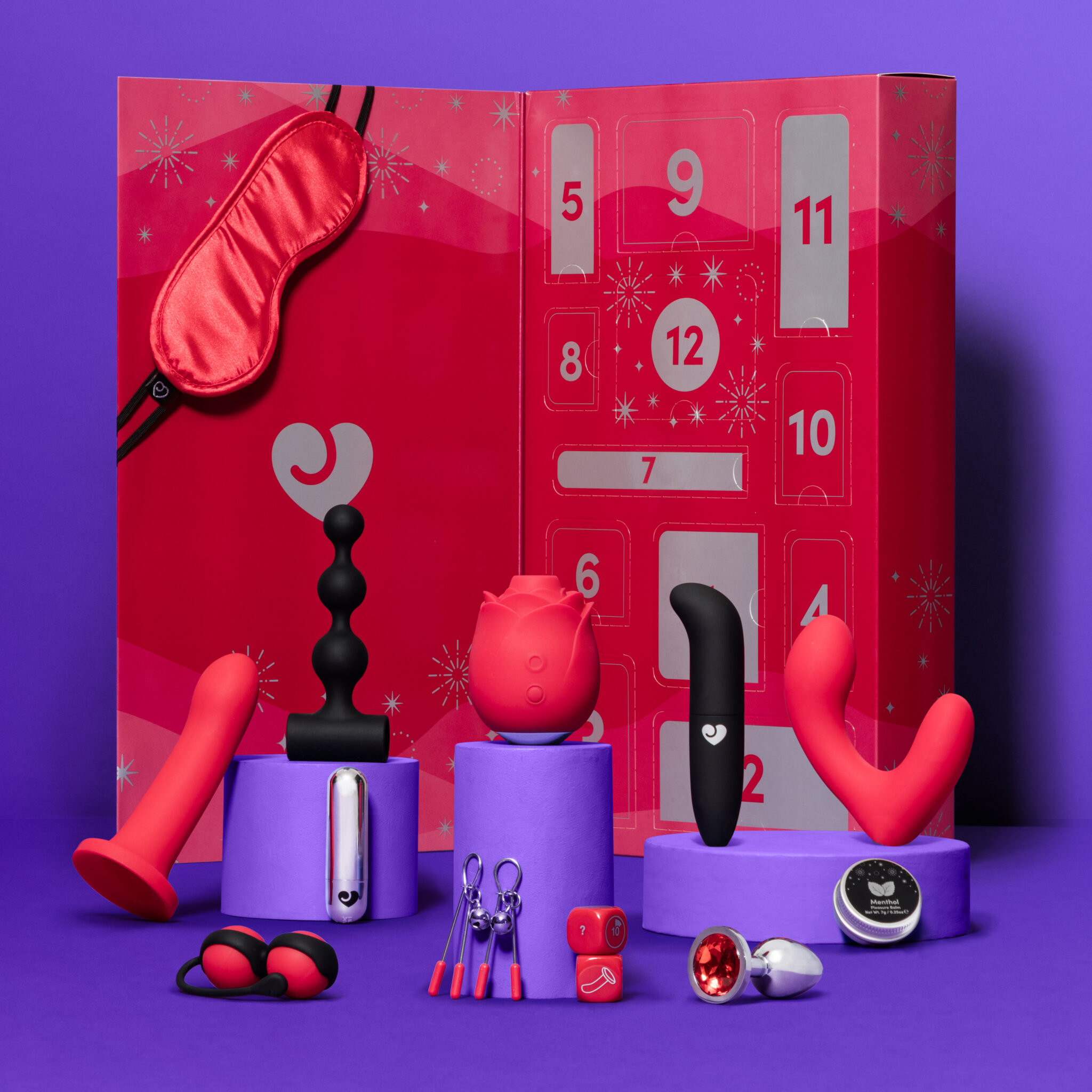 An image of some kinky and bonadge items included in the advent calendar, such as a blindfold, sex dice, and more.