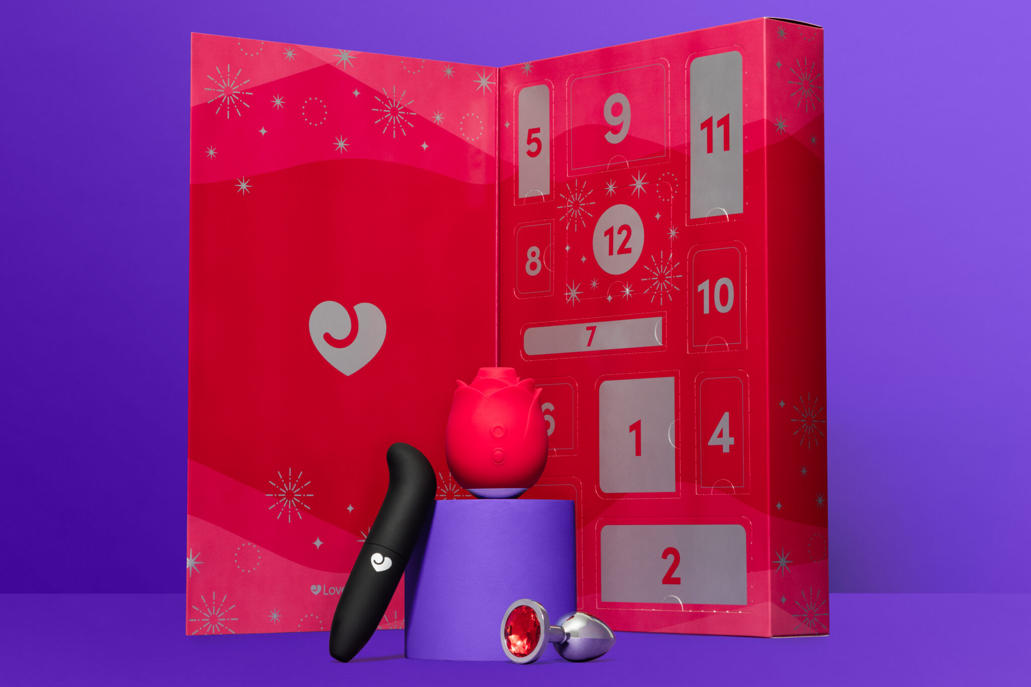A full image of three of the pieces from the 12-piece calendar, including a red jeweled butt plug.